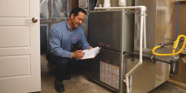 AC installation & replacement - Design Aire technician assessing an HVAC unit
